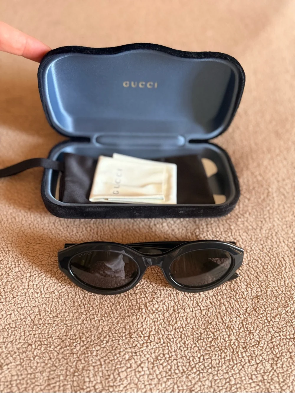 Gucci Black Oval Sunglasses with Gold Logo Accent